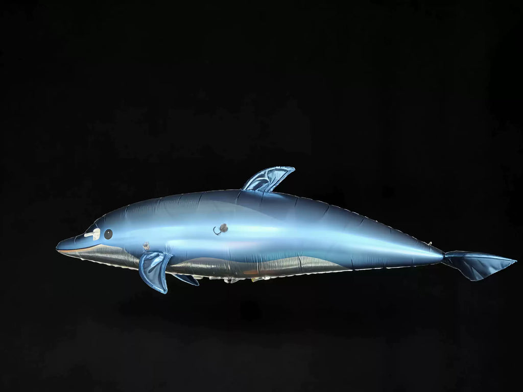 Blue remote-control dolphin blimp side view